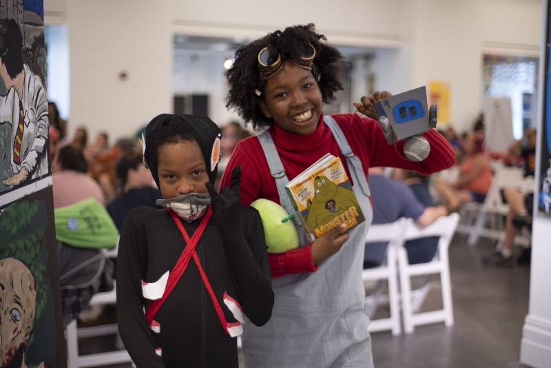 Two kids at a library comic fest