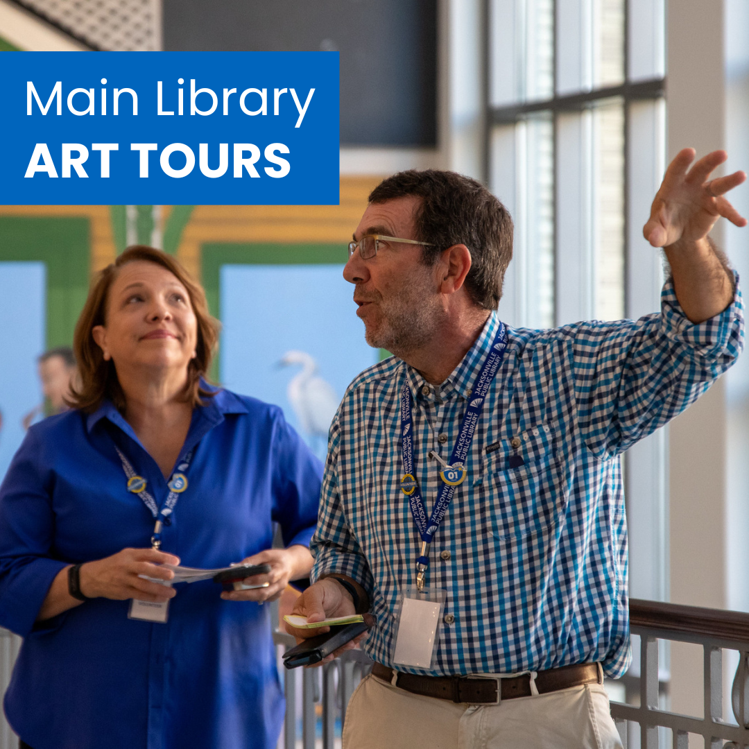 A docent raises his hand while speaking about the main library's art