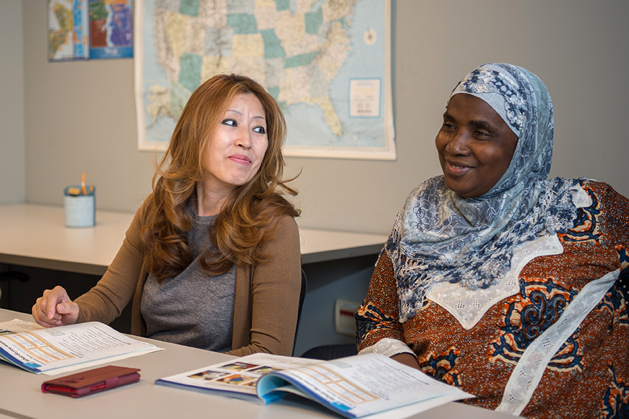 Two women learning to speak English at the Library