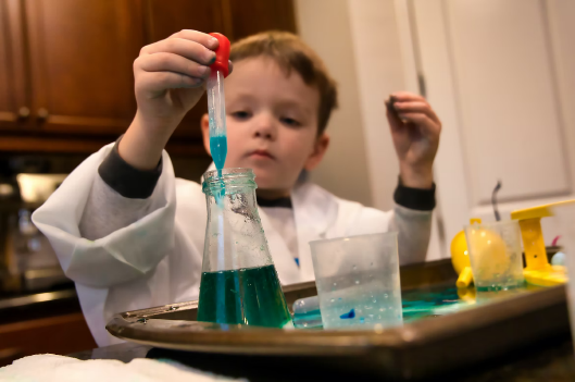 Little boy performing science experiment