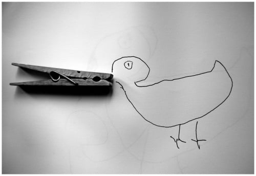 A duck drawn on paper with a clothespin for a bill
