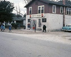 The Neighborhood Collection photo of a grocery store on a street wih people outside