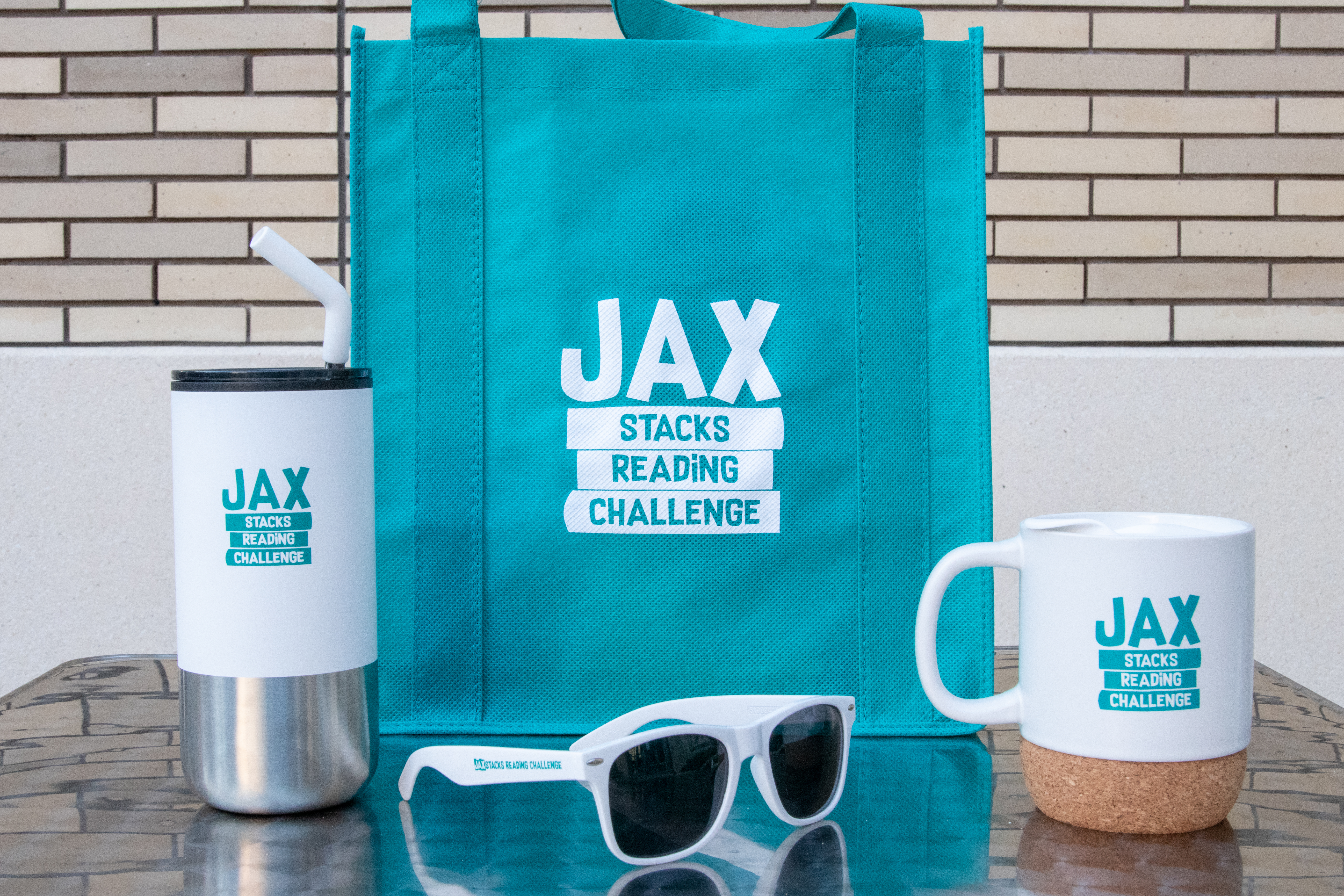 Jax Stacks branded prizes including a tote, mug, tumbler and sunglasses