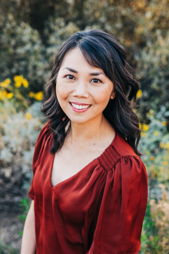 Karen S. Chow smiles to the camera, wearing a maroon blouse