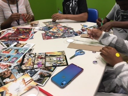 Teens make souvenir magnets from pictures in comic books at the Jacksonville Public Library