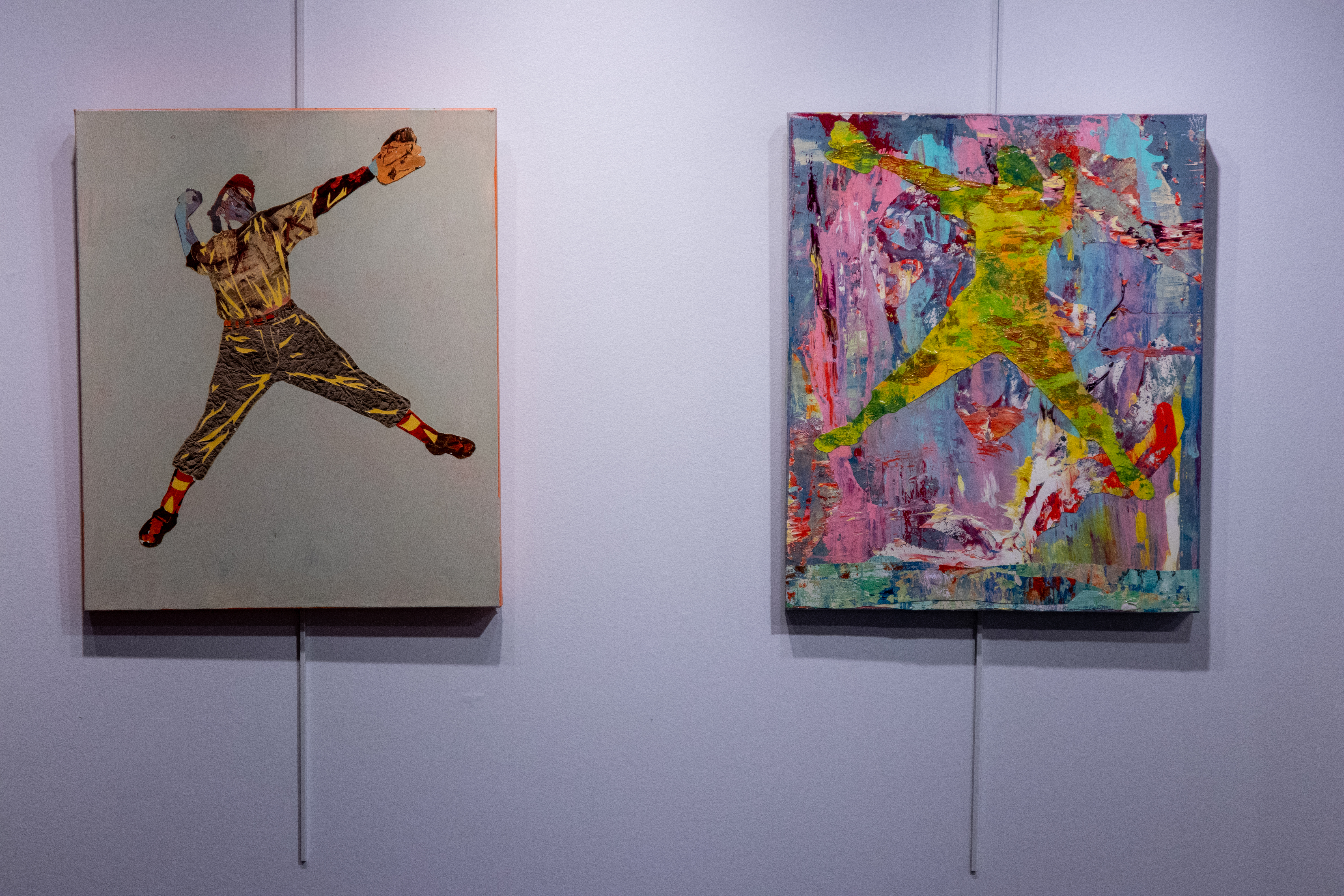 Two mixed-media paintings hanging on a wall. The figures are playing baseball. 