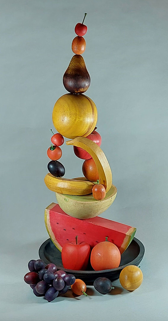 A wood sculpture resembling a large fruit basket