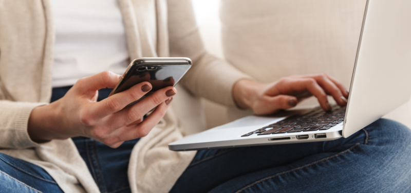 Woman with a phone and laptop