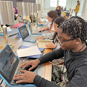 School kids on computers at the library getting history fair help in Special Collections at Main Library