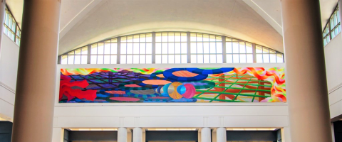 Al held abstract piece, with blue and greens and yellows