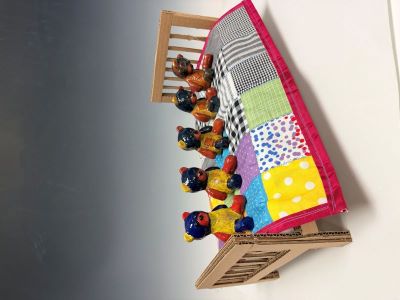 A line of fading teddy bears on a bed, ceramics