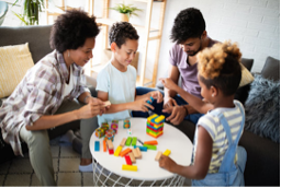 Photograph of a family playing with toys