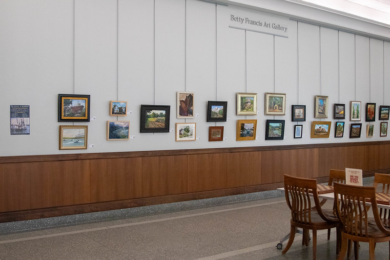 Several pieces of art hanging on a wall in the Betty Francis Art Gallery
