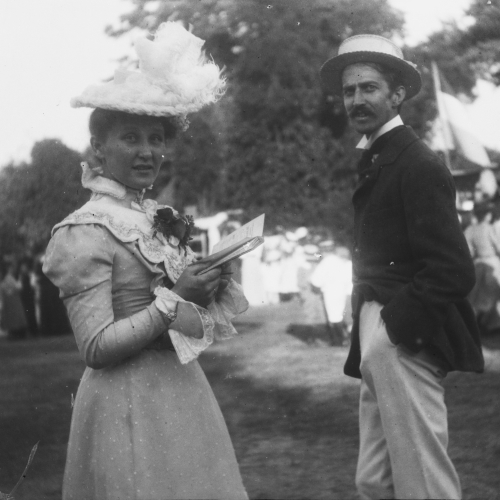 A photo of Cora and Stephen Crane. The couple are at a benefit party held in Brede Rectory Gardens, in fancy dress and hats.