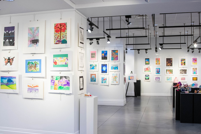 A wide shot of the main gallery featuring dozens of pieces of artwork by Elementary school students
