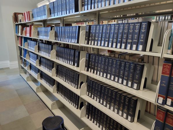 Shelves full of leather-bound genealogy books