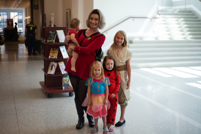 A mother in Star Trek cosplay with four children, all in different costumes from other fandoms