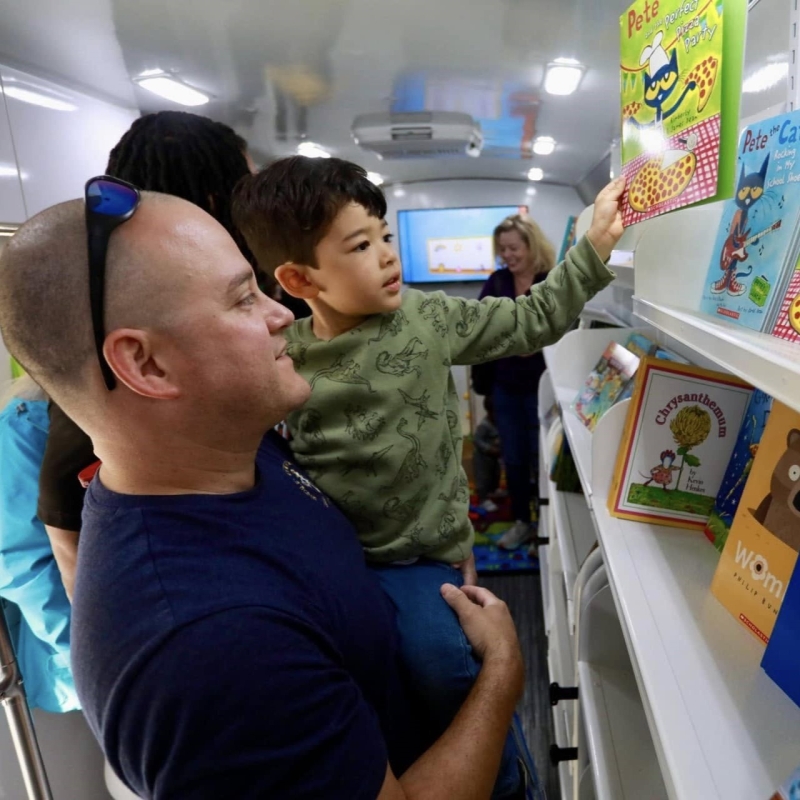 Father and son inside bookmobile