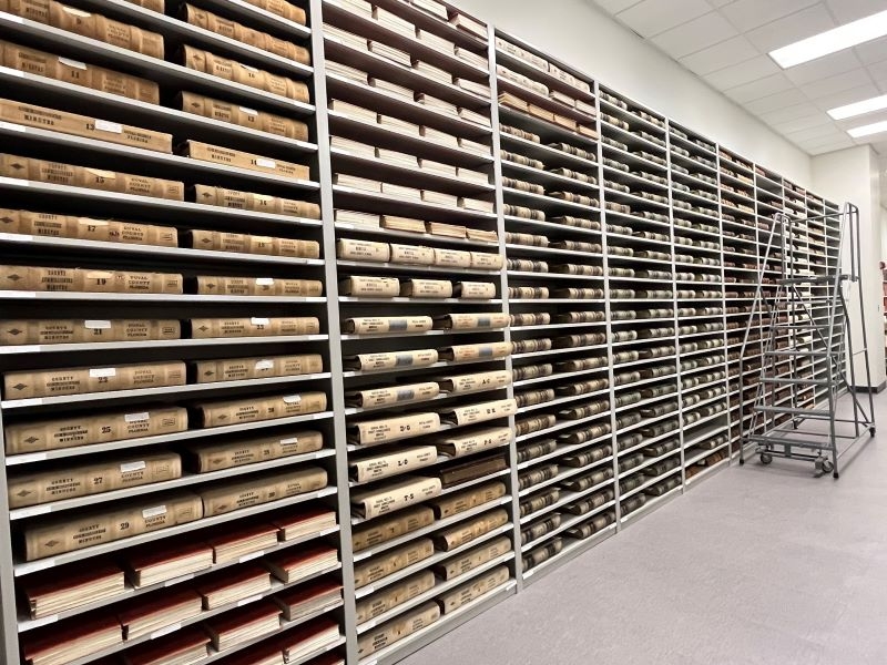 Photo of 300 plus ledgers and documents stored on shelves