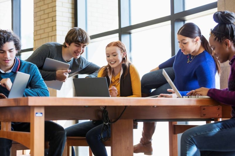 A photo of students with laptops in a study session