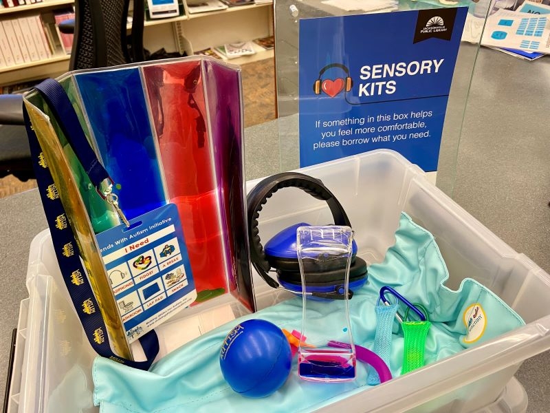 Photo of a Sensory Kit with weighted blanket, fidgets, headphones, etc.