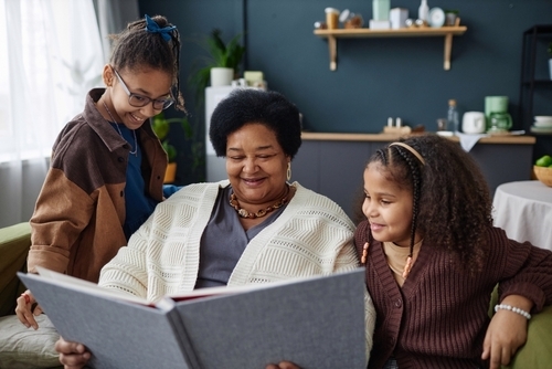 Grandmother with grandchildren and a photo album