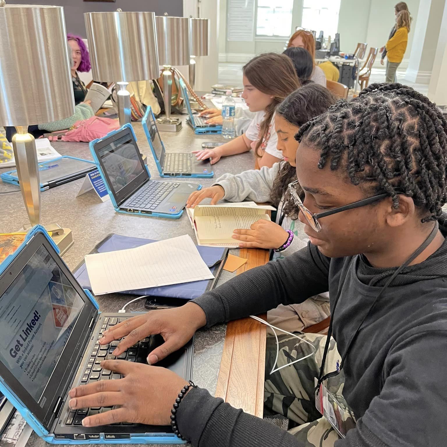 Middle school students using computers to access online databases