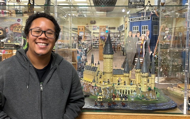 Library staff posing in front of a LEGO Hogwarts castle