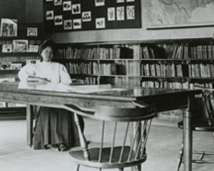 woman at a table with, interior of Main Library, downtown Jacksonville circa 1905