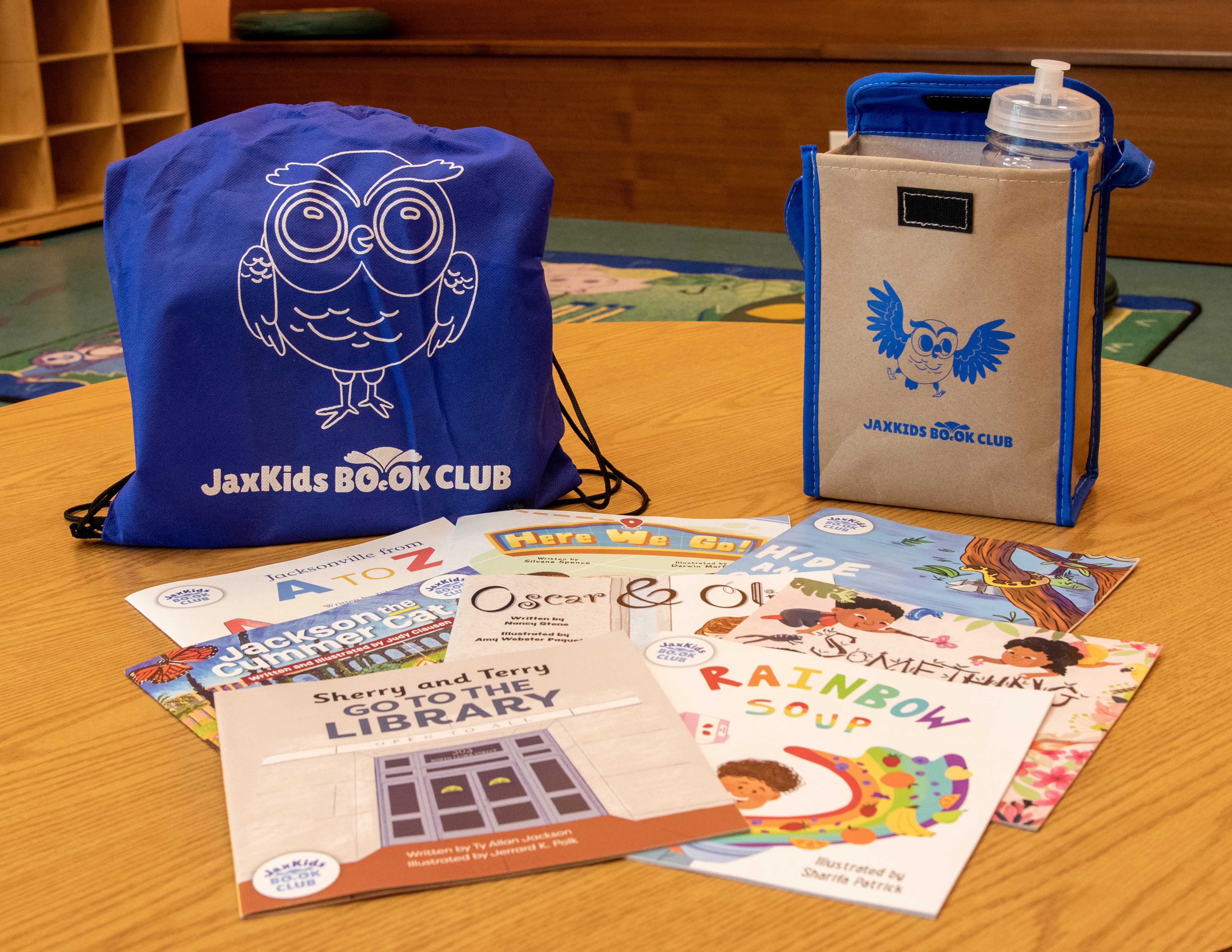 A JaxKids Book Club backpack, books, lunch tote and water bottle