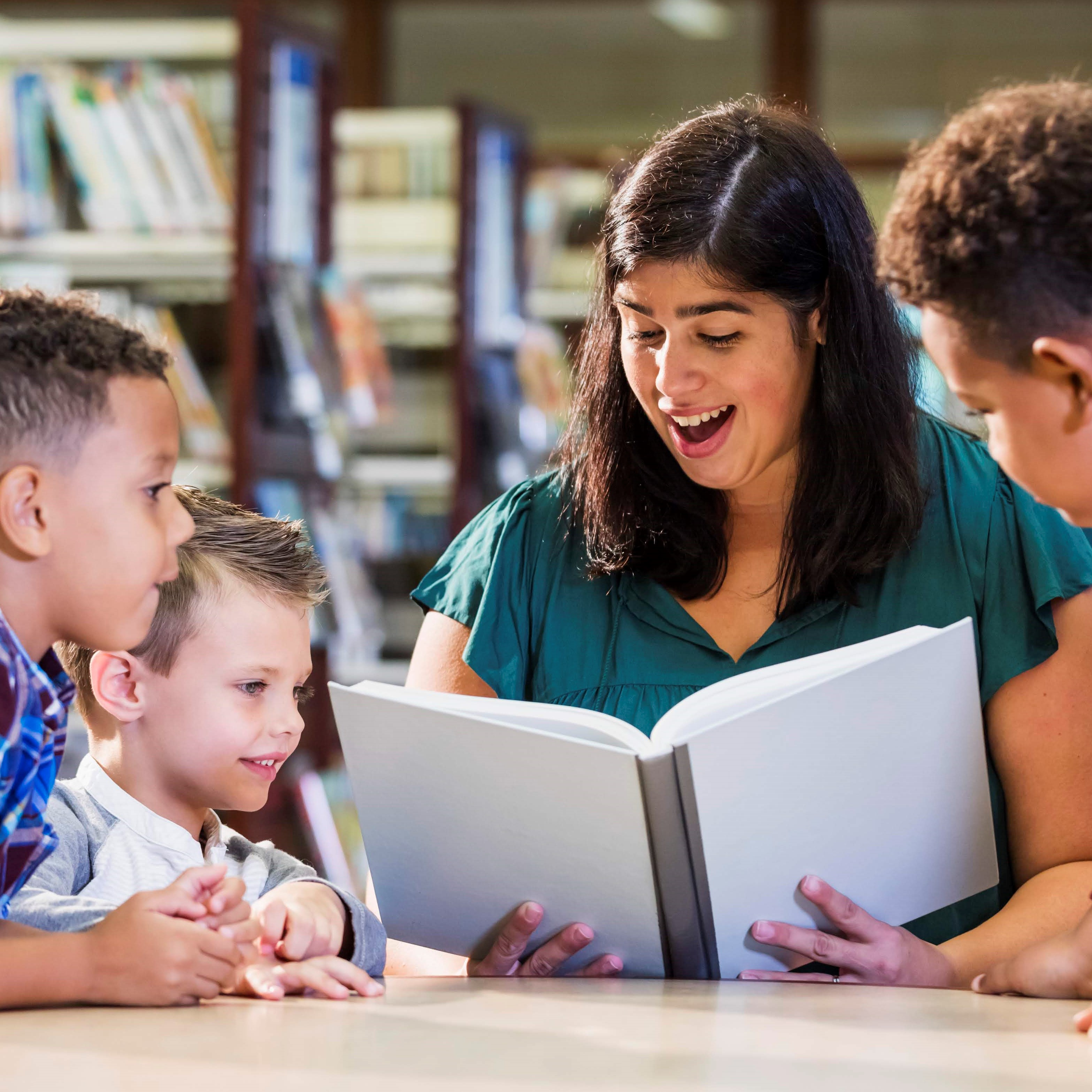 A woman reading to a group of children