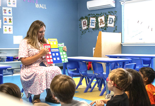 Storytime visits to VPKs woman reads to kids at a school