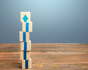 wooden blocks stacked to form an upward pointing arrow for library strategic planning