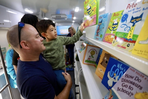 A father and son inside the bookmobile