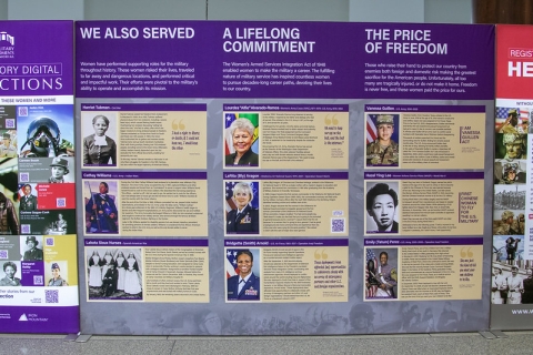 Photo of several panels in the exhibit. One is titled "We Also Served." Another is titled "A Lifelong Committment." The third is titled "The Price of Freedom." Each have photos and bios of three women.