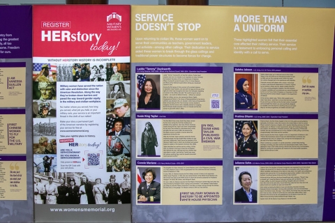 A photo of several panels in the exhibit. One is titled "Service Doesn't Stop." Another is called "More Than a Uniform" Each as photos and bios of three women. Another panel asks for more stories and has a QR code for submissions.