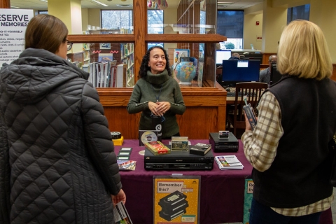 Tammy Kiter, library staff member, talks to customers about the Memory Lab