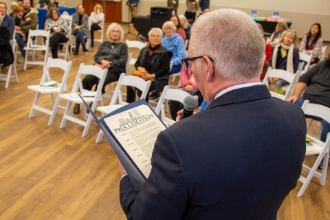 Photo of Library Director Tim Rogers reading from the Mayor's Proclamation marking the 75th anniversary of San Marco Branch Library.