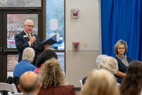 Photo of Library Director Tim Rogers reading from the Mayor's Proclamation marking the 75th anniversary of San Marco Branch Library.