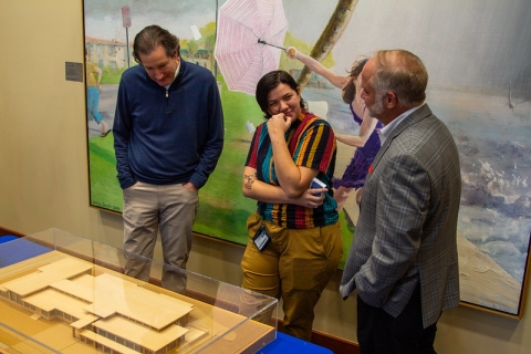 Library staff member, AJ Ferraro, talks to the architect who designed the expanded San Marco Branch Library and Balis Center. They are both standing next to the scale model.