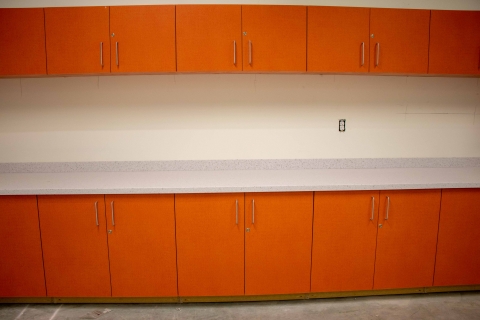 Cabinets painted orange with table top installed in the Highlands Regional Library Children's area