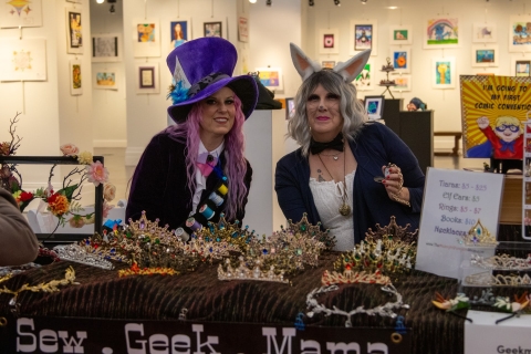 A photo of two cosplayers selling tiaras