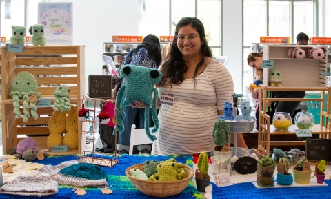 Photo of a vendor with her crocheted creations