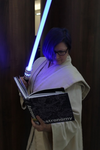 A Jedi Master looking through an Astronomy book