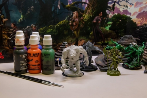 Painted and unpainted miniatures, with paint and a paint brush
