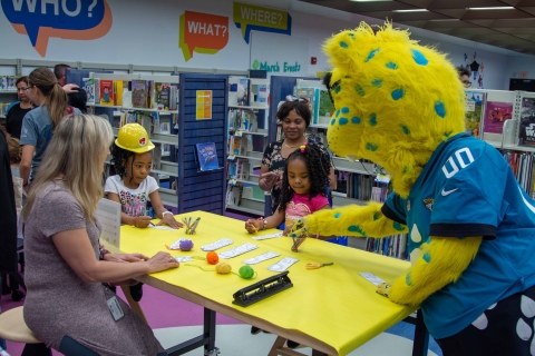 Jaxson de Ville doing crafts with children