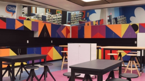 A space with colorful cabinets and tables for crafts