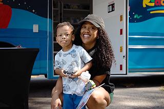 mother and child attend a bookmobile event