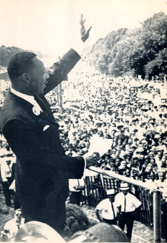 Dr. Martin Luther King Jr. waves to the crowd gathered in front of the Lincoln Memorial