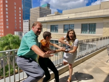 Cole Pepper in a Heisman pose, Hurley handing Jenna off a book like a football move on the balcony of the main library.